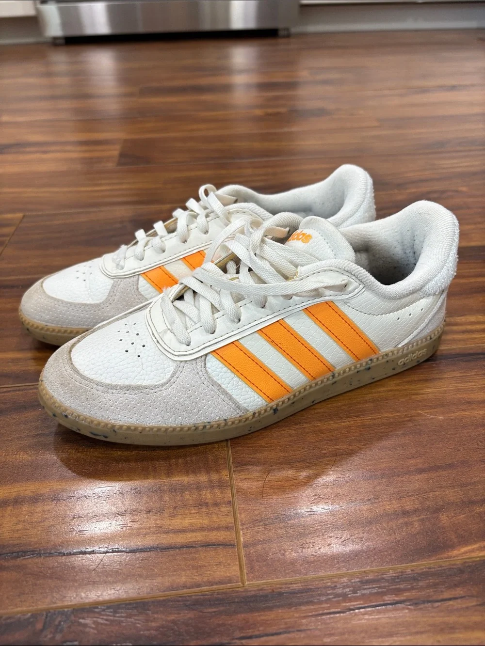 adidas Women’s White Sneakers with Orange Three-Stripes
